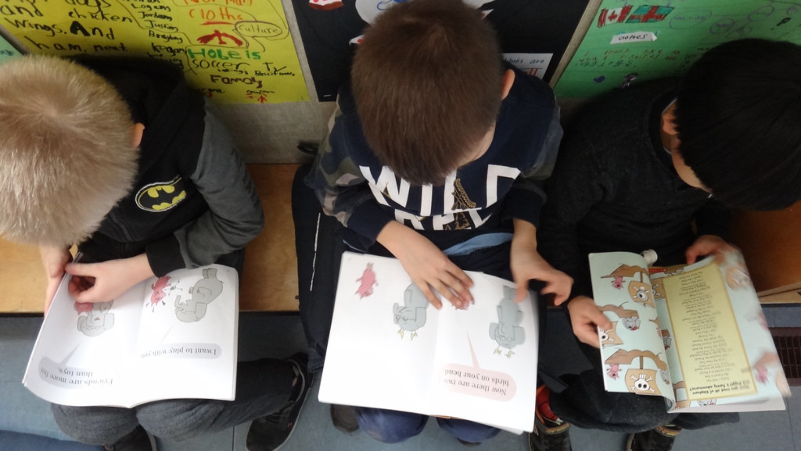 photo of three children reading