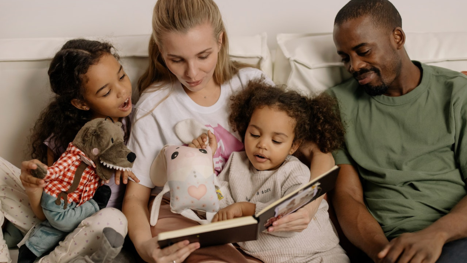 photo of a family of four reading together