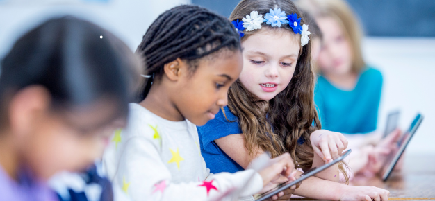 photo of girls using a tablet