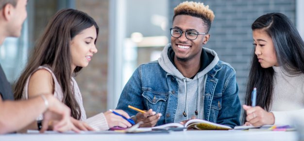 photo of a group of teens writing