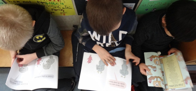 photo of three boys reading