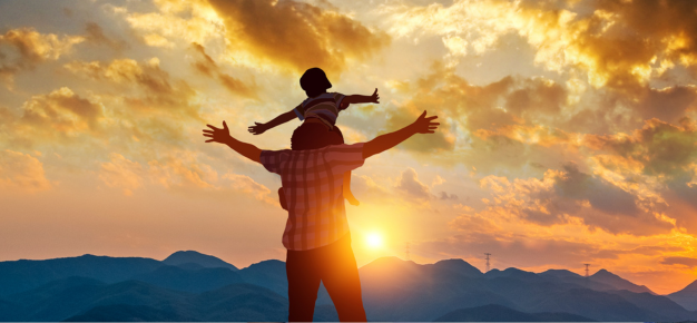 photo of a father and child at sunset