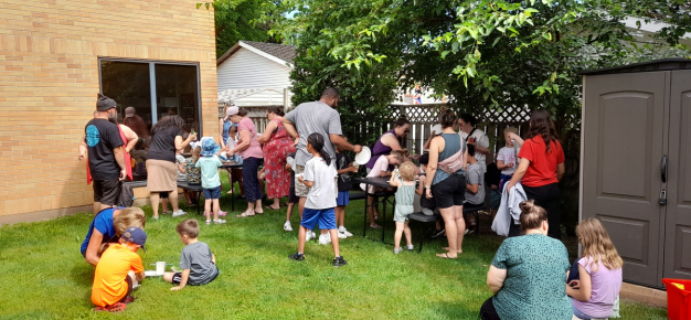 photo of parents and children in the St. Paul Library backyard