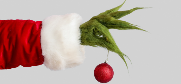 photo of the grinch's arm holding a holiday decoration