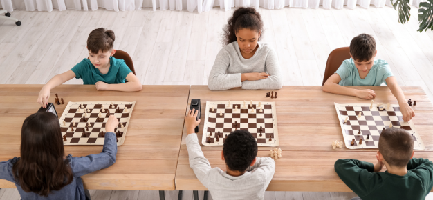 photo of a group of children playing chess