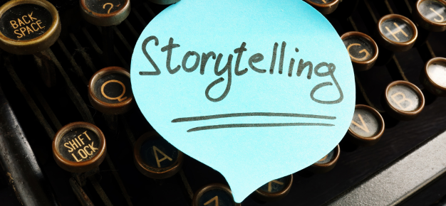 post-it note with the word storytelling on a keyboard