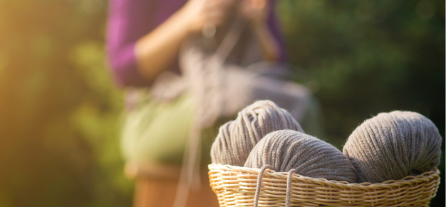 photo of a person knitting outside